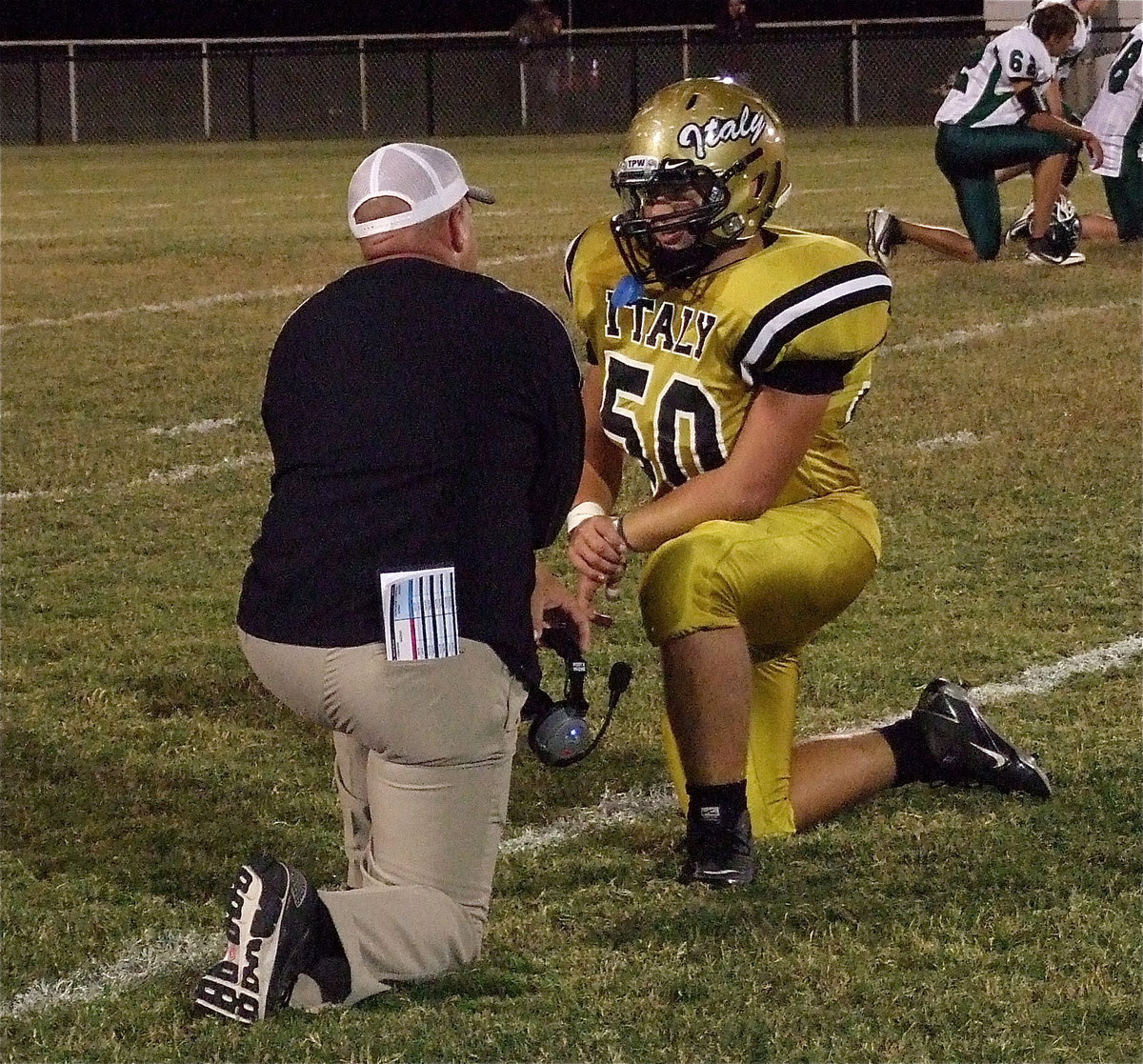 Image: Coach Hollywood has a one-on-one talk with defensive tackle Zain Byers(50).