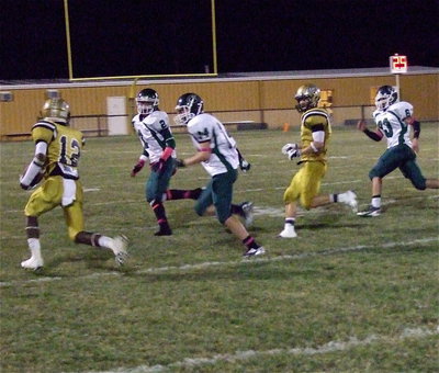 Image: Eric Carson(12) gains yards with teammate Chase Hamilton(2) looking for someone to clock.