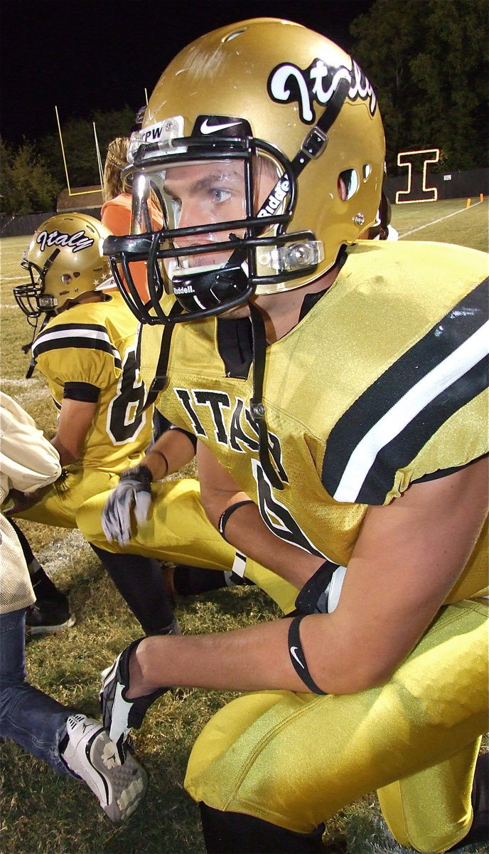 Image: Senior Gladiator Cole Hopkins and his teammates take a knee during an injury timeout in a show of respect for the injured Bobcat. Hopkins had 3 catches for 77 yards and 1 touchdown and punted just once during the game for 50 yards.