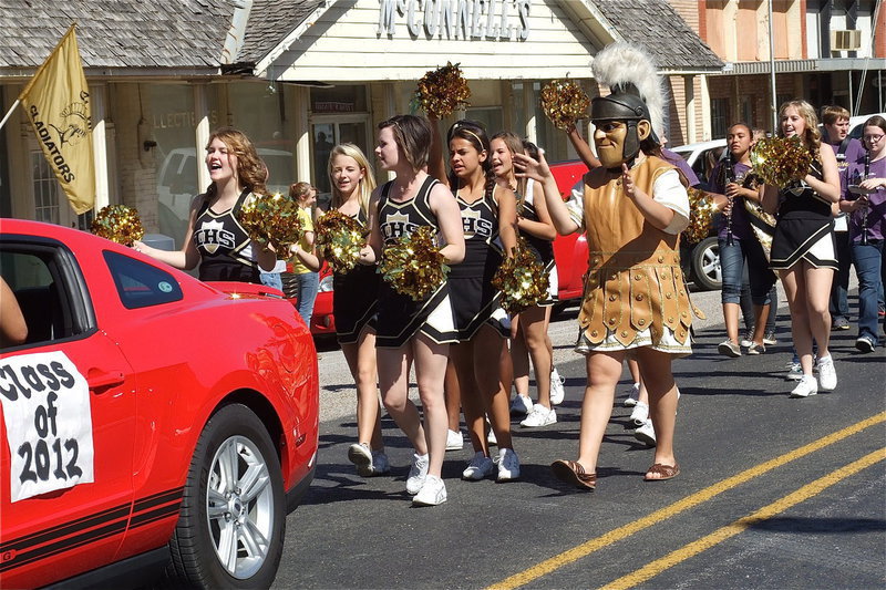Image: The IHS cheerleaders and mascot Reagan Adams fill the streets with spirit!