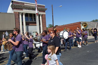Image: The award-winning Gladiator Regiment Marching Band blares the “Beat of Champions” down main street, between the buildings and into the surrounding neighborhoods.