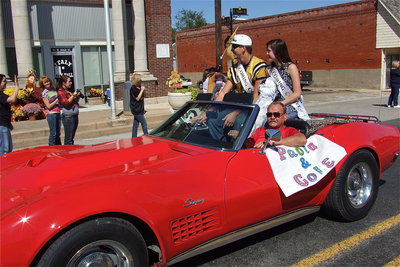 Image: Ronnie Hyles zooms 2012 Homecoming King nominee Cole Hopkins and Homecoming Queen nominee Paola Mata down main street during the parade.