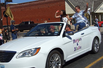 Image: 2012 Homecoming Queen nominee Morgan Cockerham and Homecoming King nominee Blake Vega offer candy to their fans.