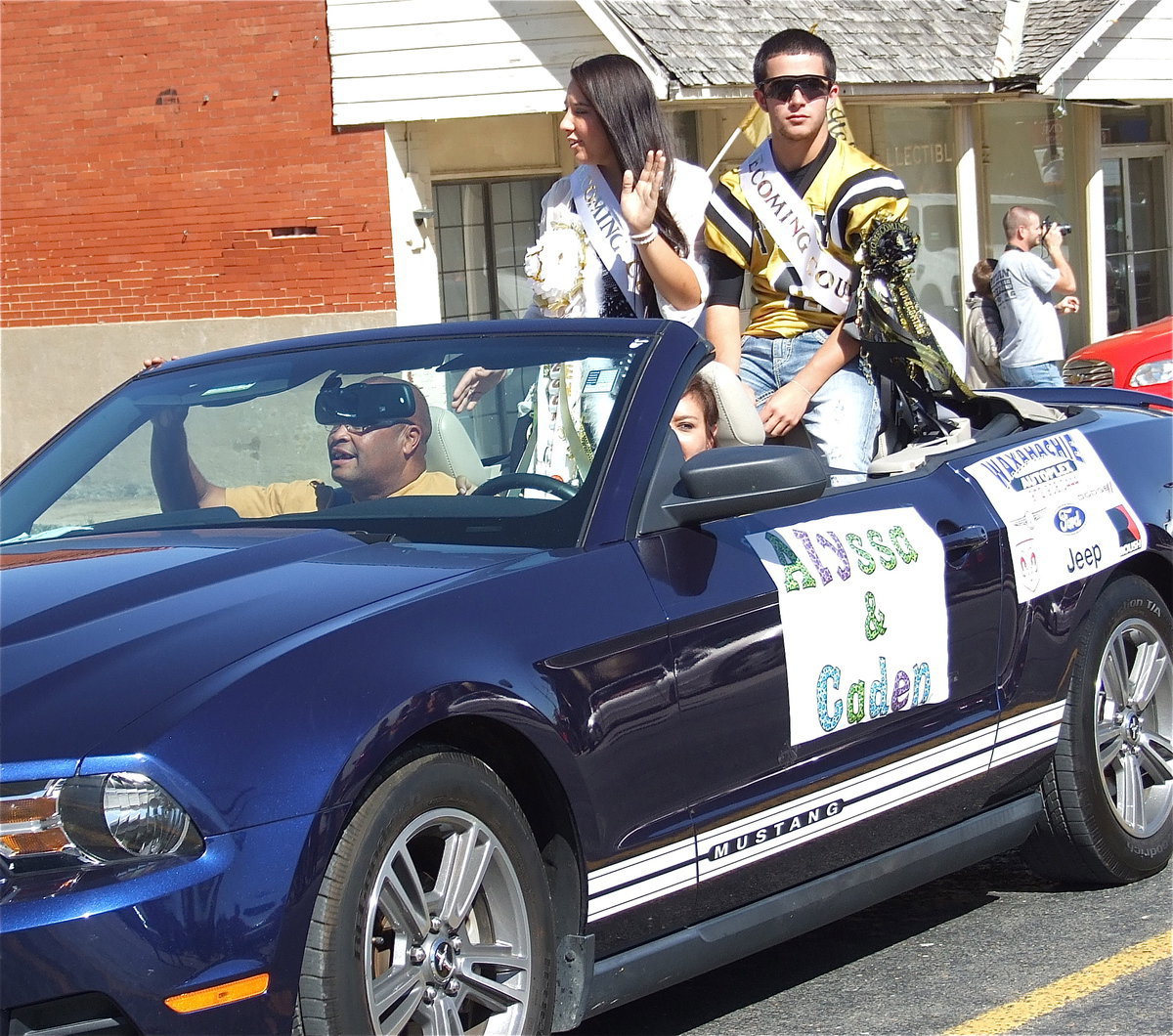 Image: 2012 Homecoming Queen nominee Alyssa Richards and Homecoming King nominee Caden Jacinto(6) are escorted down the parade path by Tina Richards (mom) and Larry Mayberry, Sr.