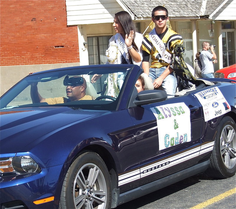 Image: 2012 Homecoming Queen nominee Alyssa Richards and Homecoming King nominee Caden Jacinto(6) are escorted down the parade path by Tina Richards (mom) and Larry Mayberry, Sr.