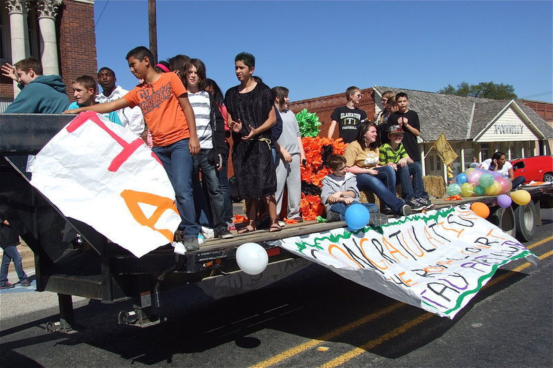 Image: School spirit, demonstrated here by the IHS Art Club, floats by Italy City Hall during the 2012 Homecoming Parade.