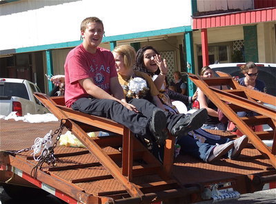 Image: Bailey Walton, Jesica Wilkins and Monserrat Figueroa are enjoying riding in the parade on the junior class float.