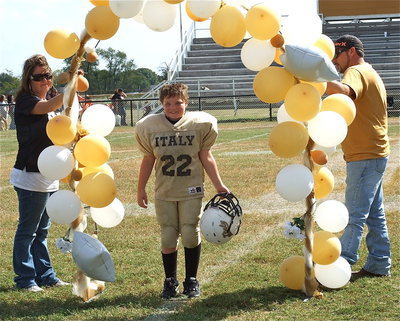 Image: IYAA A-Team Gladiator Aedan Brewer(22) is honored during homecoming.