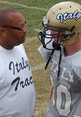 Image: Assistant coach Larry Mayberry, Jr., and Cody Boyd talk Gladiator-to-Gladiator.