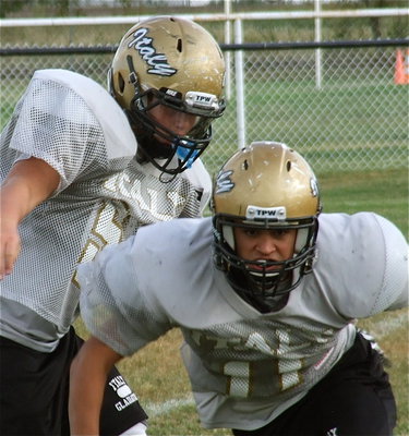 Image: Defensive tackle Reid Jacinto(11) works on ripping thru with Zain Byers(50).