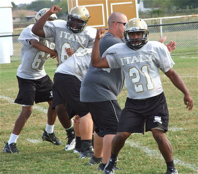 Image: Adrian Reed(64) and Jalarnce Jamal Lewis(21) work on rip technique with assistant coach Brandon Duncan.
