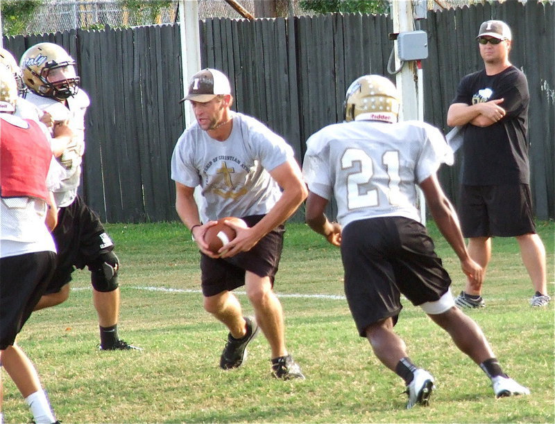 Image: Zackery Boykin(55) and Jalarnce Jamal Lewis(21) close in on Cayuga’s Q.B., aka Coach Skelton.