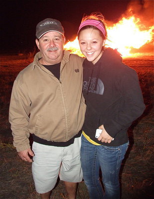 Image: Italy School Board president Larry Eubank with his daughter Bailey Eubank, who is a Lady Gladiator sophomore, enjoy the homecoming bonfire together.