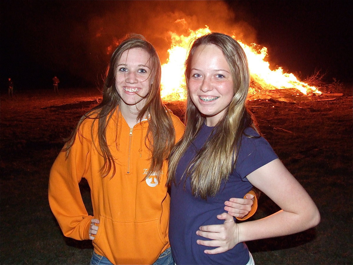 Image: IHS Color Guard member Brooke Miller and Gladiator Regiment Band member Maddie Pittman enjoy the homecoming bonfire.