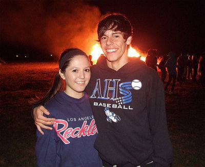 Image: Paola Mata, a member of the Lady Gladiator Volleyball team and Kelvin Joffre, who plays for the Gladiators, celebrate homecoming during the bonfire.