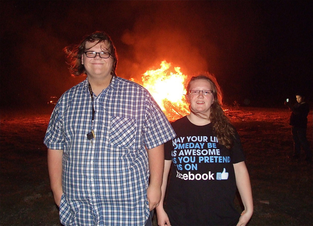 Image: Siblings Logan Owens and Samantha Owens enjoy the bonfire together.