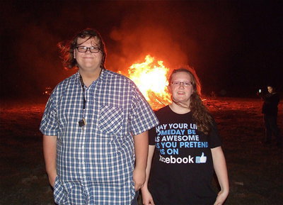 Image: Siblings Logan Owens and Samantha Owens enjoy the bonfire together.