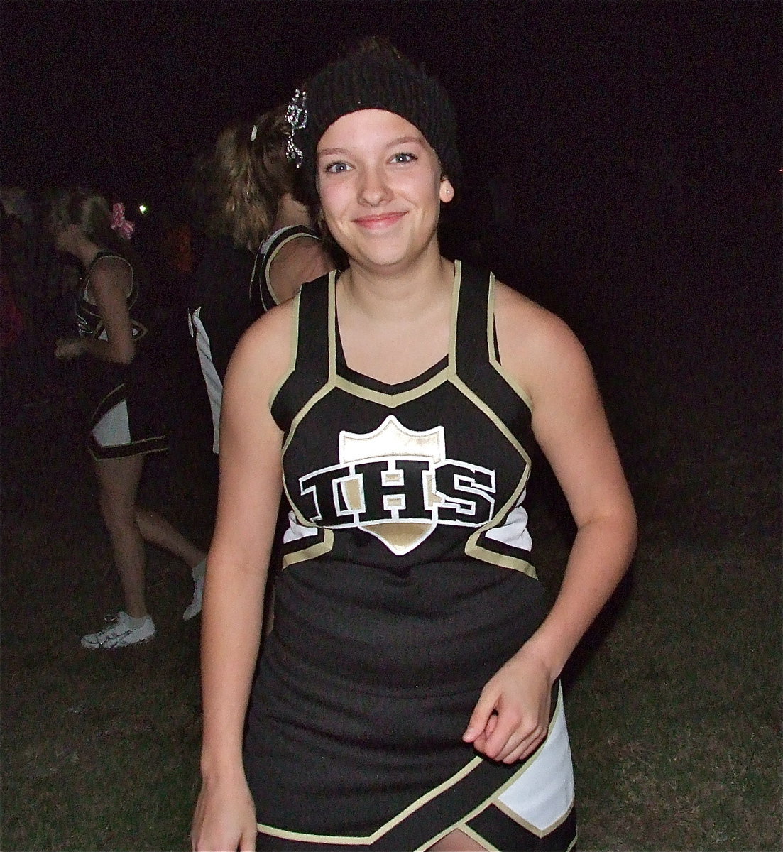 Image: Senior cheerleader Morgan Cockerham keeps fans smiling during the bonfire.