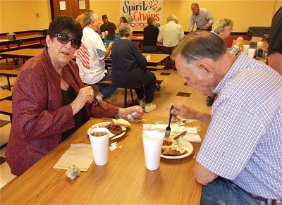 Image: Brenda and Ferrell Smithey partake in the feast to help support recipients benefitting from the annual George Scott Memorial Scholarship Fund barbecue dinner.