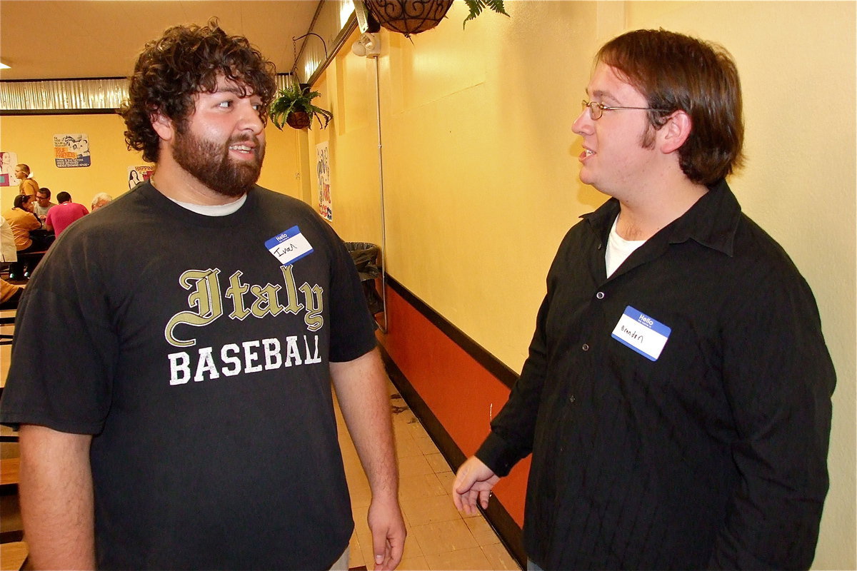 Image: Ivan Roldan and Brandon Owens are scholarship recipients stopping to catch up with one another while mingling with guests.