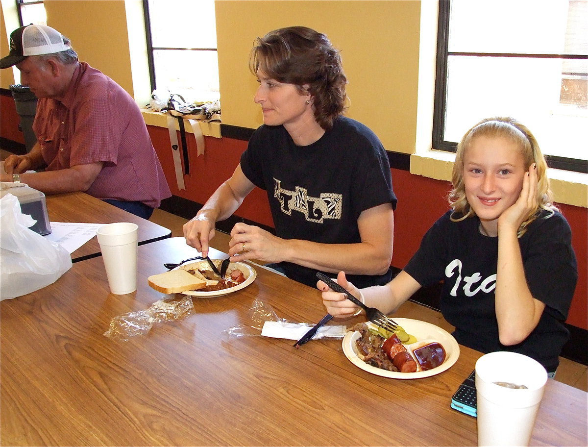 Image: Richard Cook, Michele Riddle and her lovable daughter Courtney Riddle dig right in.