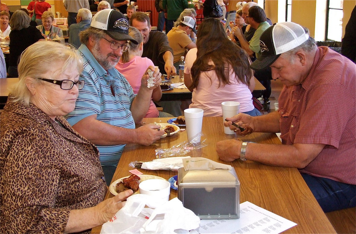 Image: Mark Hamilton and his wife, Carolyn, and Richard Cook have little time for small talk during the meal. Priorities.