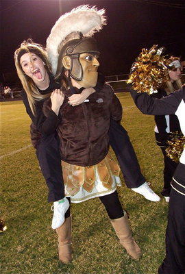 Image: Kelsy Nelson hops a ride on the back of Gladiator mascot Reagan Adams.