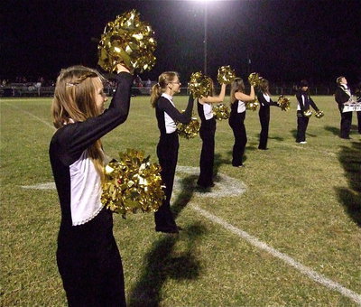 Image: Brooke Miller, Anna Rose and their fellow color guard members substitute pom-pons for flags without missing a beat during halftime.