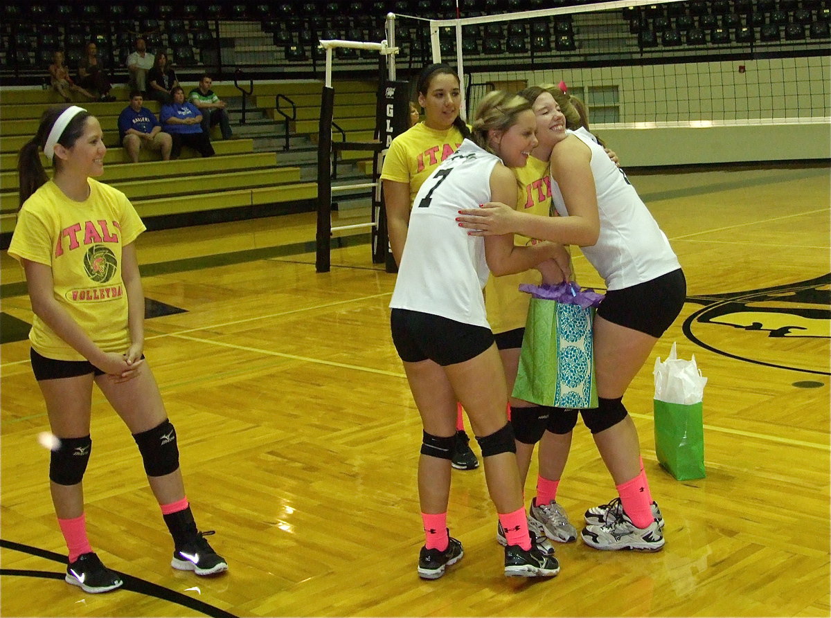 Image: Bailey Eubank and Madison Washington congratulate senior Morgan Cockerham and present her with a gift bag.