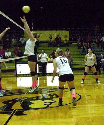 Image: Madison Washington(10) springs into action at the net at middle blocker while Jaclynn Lewis(15) and Paige Westbrook(12) have her back.