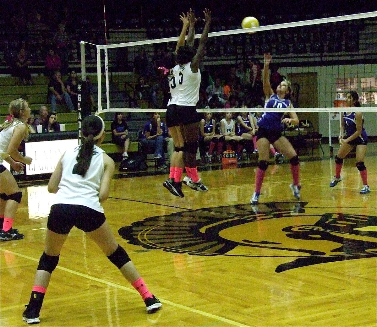 Image: Alyssa Richards(13) and Kortnei Johnson(3) make a wall above the net against Covington.