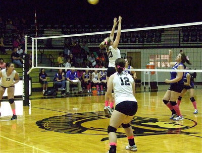Image: Alyssa Richards(13) and Paige Westbrook(12) are at the ready as Madison Washington(10) goes for the block.