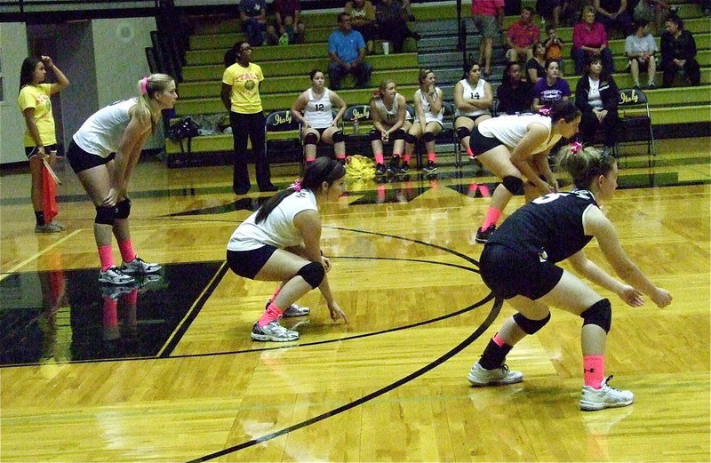 Image: Coach Jessika Robinson looks on from the sideline as Madison Washington, Morgan Cockerham, Alyssa Richards and Tara Wallis(5) await a Covington serve.