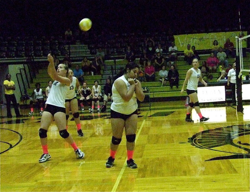 Image: Madison Washington(10) bumps the ball back over to Covington as Monserrat Figueroa(14) avoids colliding with Washington.