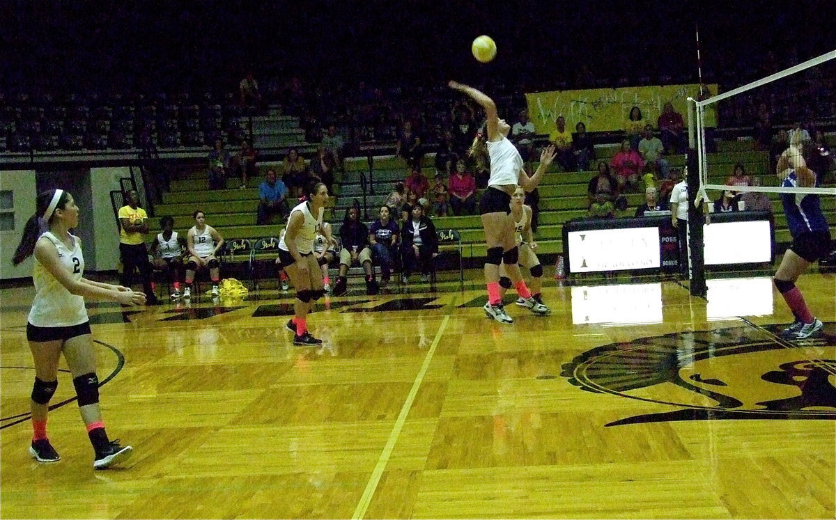 Image: Madison Washington(10) goes high for a point against Covington.