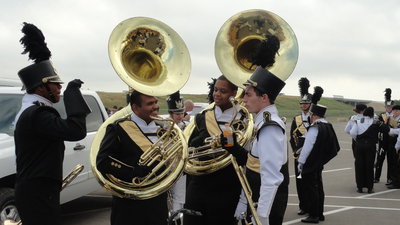 Image: Brass section members discuss strategy.