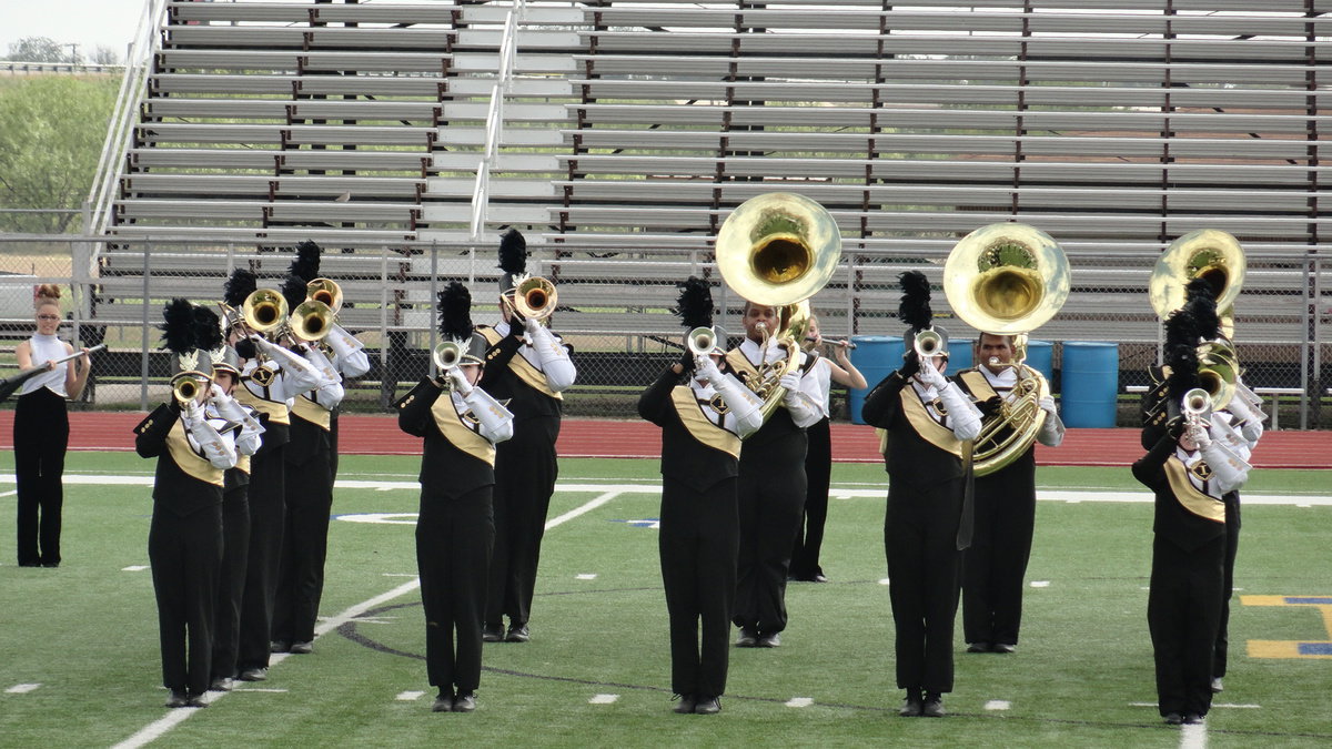 Image: The brass section performs.