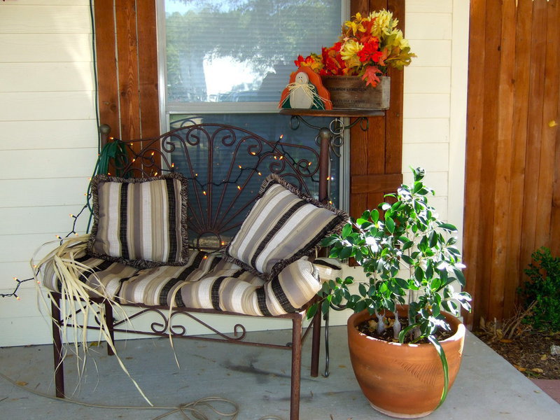 Image: Their front porch is decked out with plants, fall flowers and topped off with candy corn lights.