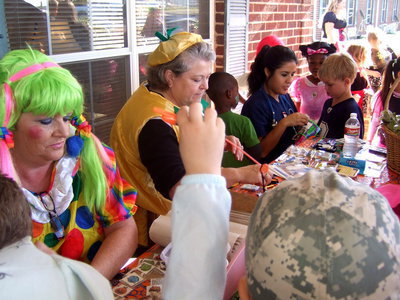 Image: Face painting and sticker craft going on here.