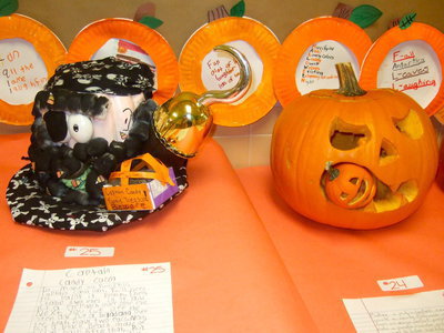 Image: Two cute jack-o’-lanterns — a ghost and a pumpkin eating a pumpkin.