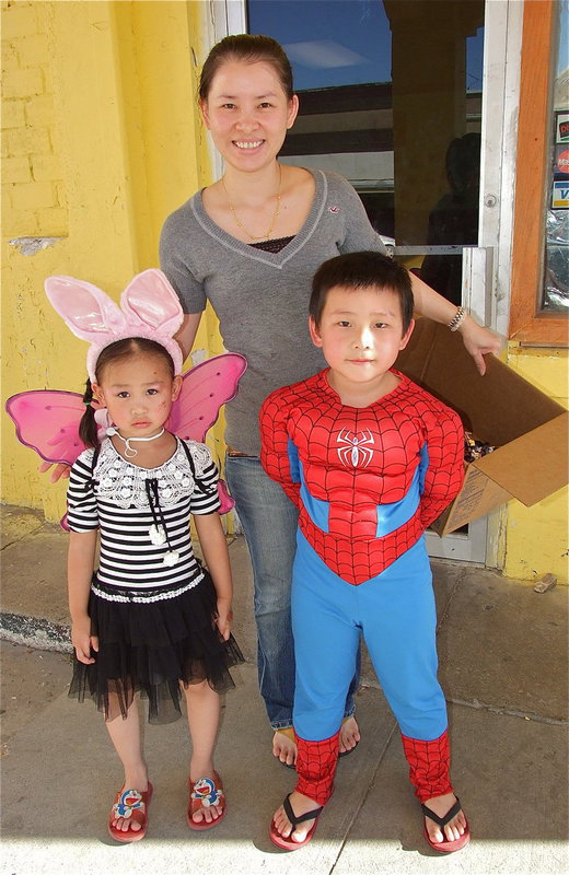 Image: Mei Lin, Butter-babbit Annie and Spiderman Evan offer trick-or-treaters candy from the haunted chinese buffet of Keng Wok.