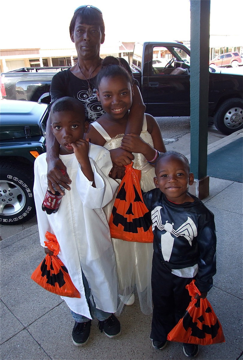 Image: Trick-or-treaters were all smiles in downtown Italy on Wednesday with Halloween bags being filled with candies and treats.