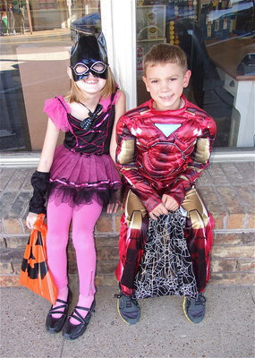 Image: A precious ballerina and Iron Man take a break from trick-or-treating from business to business.
