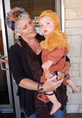 Image: Robin treats the babies with care who joined the fun during trick-or-treat on main street in Italy.