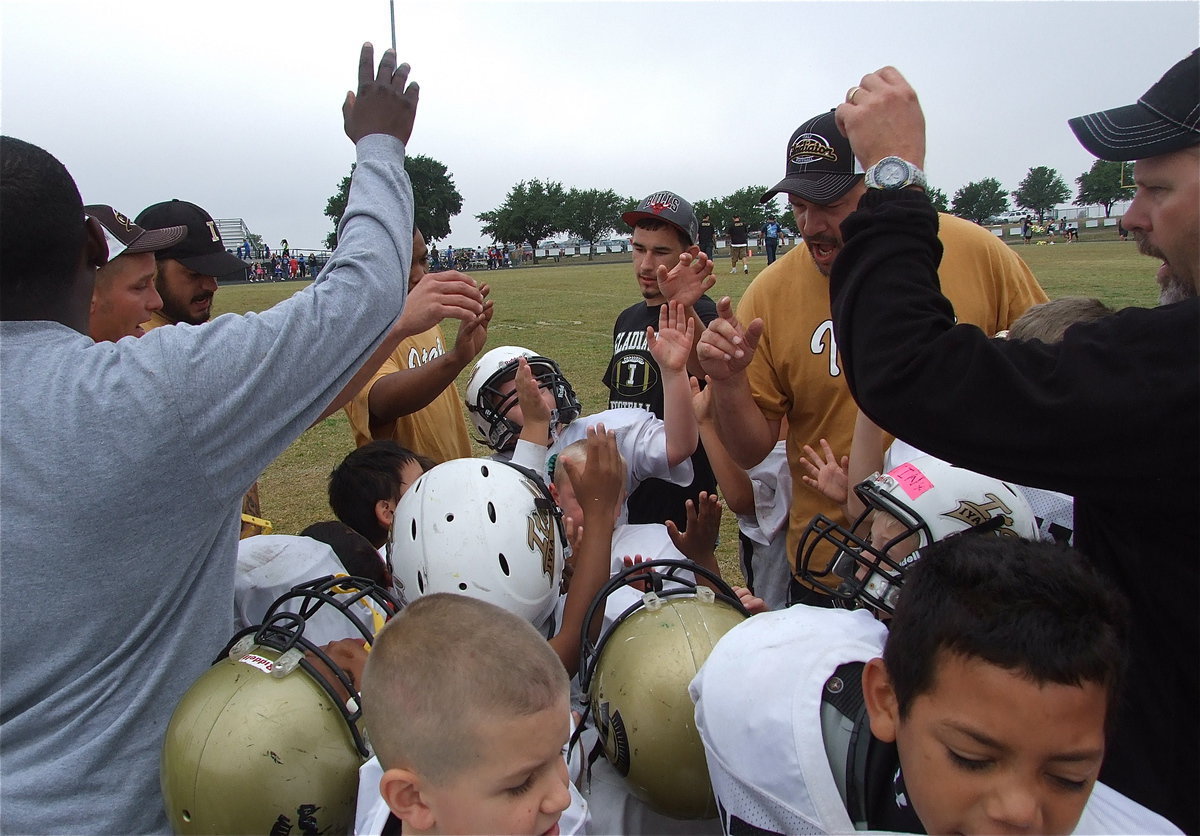 Image: The C-team Gladiators finish as conference championship finalists after losing to Blooming Grove 12-7 in the game’s final minutes. The coaches and players huddle one last time vowing to return to the playoff’s next season.