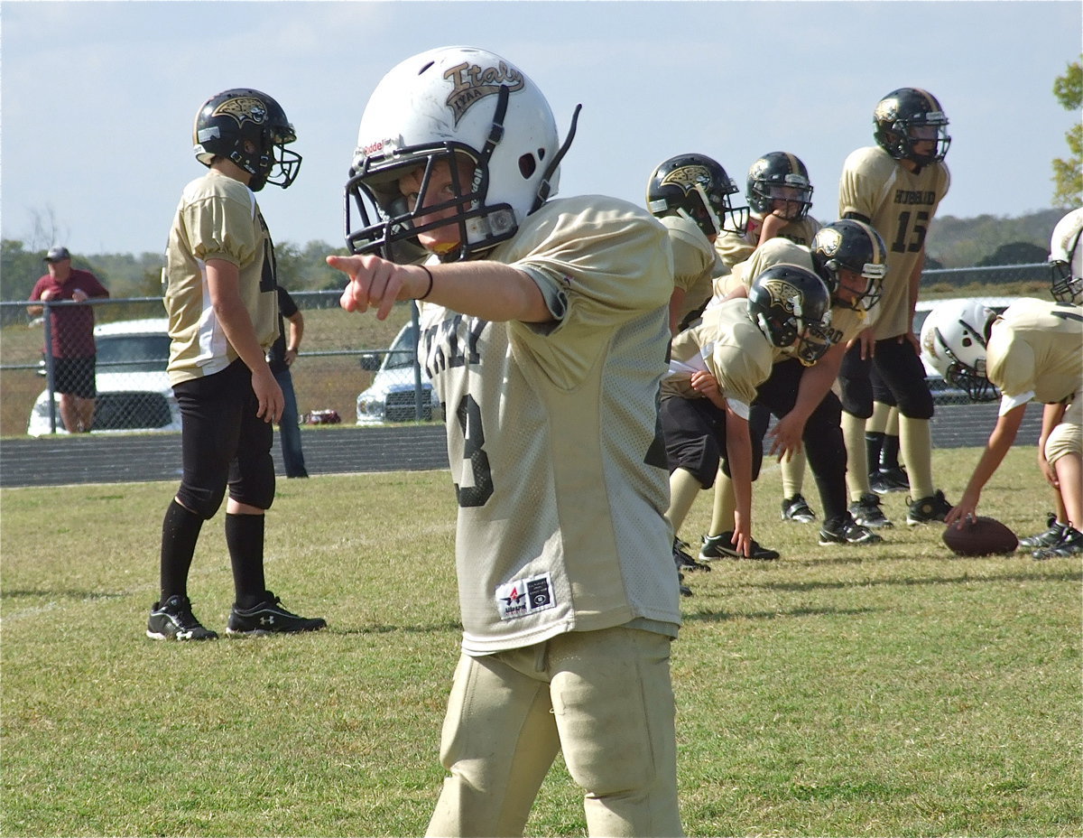 Image: A-team Gladiator, Garrett Cash(28) checks with the sideline official for proper alignment before the snap.