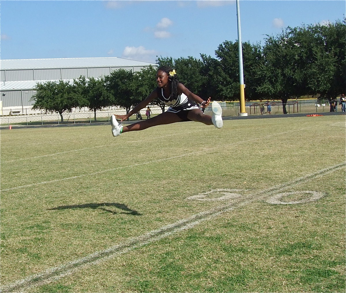 Image: Wow! IYAA A-team cheerleader Sha’Niaya Johnson helps lift her squad into the NEH Superbowl cheer competition.