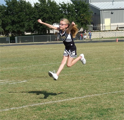 Image: A spirited Madelyn Chambers helps leap the IYAA A-team cheerleaders into the NEH Superbowl cheer competition.