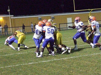 Image: Gladiator left offensive guard Darol Mayberry(58) throws a downfield block as Kelvin Joffre(80) helps push receiver Eric Carson(12) closer to the goal line.