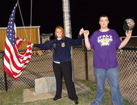 Image: IHS senior Katie Byers and freshman Austin Pittmon represent the Italy FFA while participating in the school song before raising the stars and stripes. Byers was sad but proud to have the honor of raising the flag one last time, or at least attempting to.